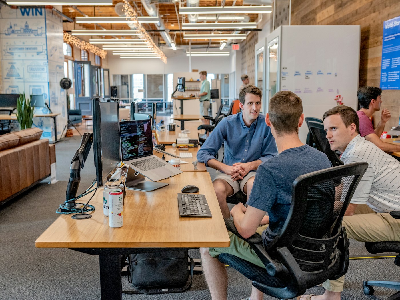 Business team discussing a customer workflow in an open office